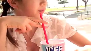 Elegant Japanese angel Aki Hoshino eats ice cream in the park